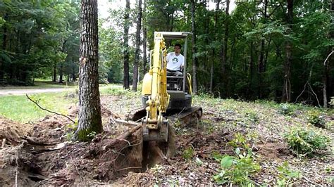 digging out stumps with mini excavator|mini excavator clearing trees.